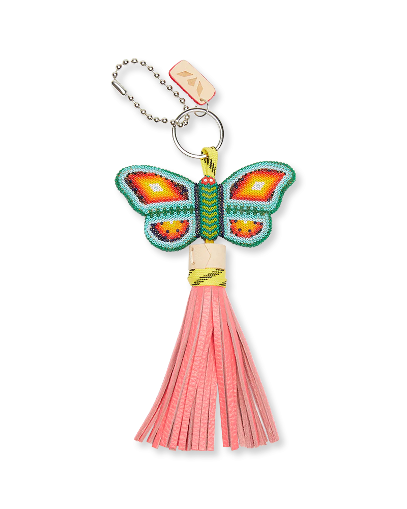 Butterfly keychain with pink tassel on a white background